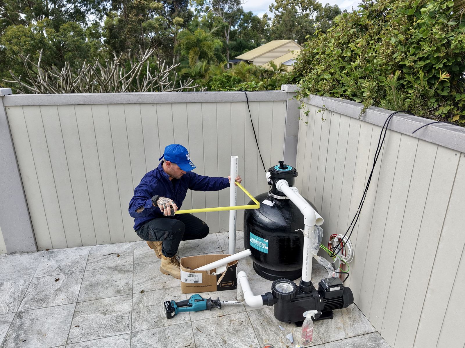Blue Avenue Pools installing and measuring up pool equipment