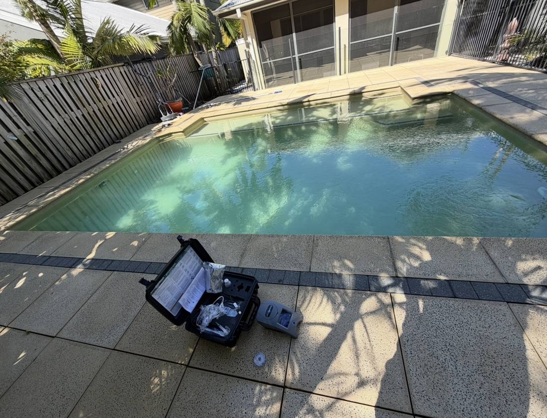 Blue Avenue Pools testing water chemistry on a green pool before recovery