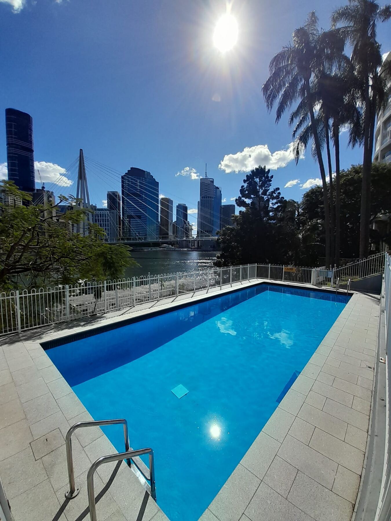 Blue Avenue Pools client pool overlooking the river and city skyline