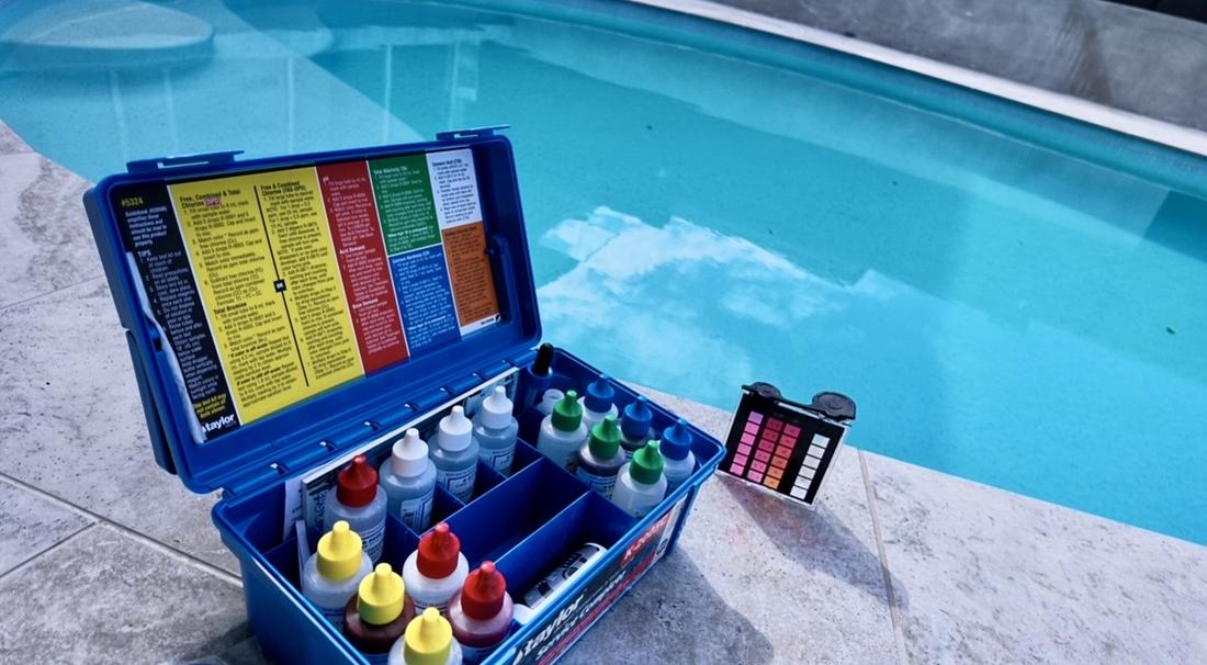 Taylor water chemistry test kit beside a Gold Coast pool